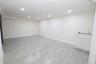Open concept room featuring recessed lighting, light-toned plank flooring, and a built-in cabinet with a countertop and sink