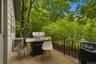 Outdoor patio featuring a concrete surface and black metal railing