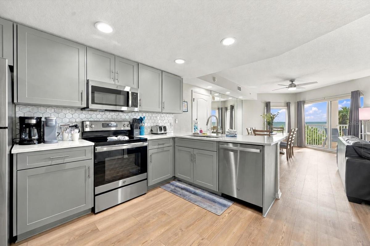 Updated Kitchen with Quartz Countertops, Stylish Backsplash, LVP Flooring and Gulf Views