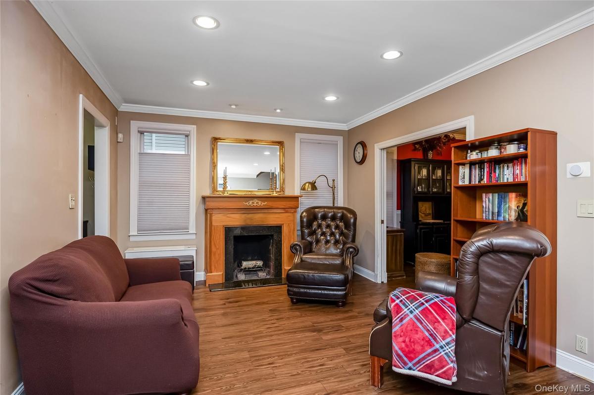 Relax by the fire in this welcoming living room with a wood-burning fireplace.