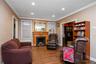 Relax by the fire in this welcoming living room with a wood-burning fireplace.