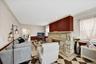 Spacious and bright living room with stone wood burning fireplace