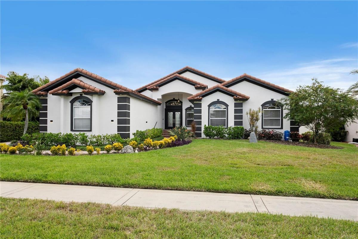 Welcome home to 6402 Rubia Circle in Andalucia, a beautiful gated community in Apollo Beach!