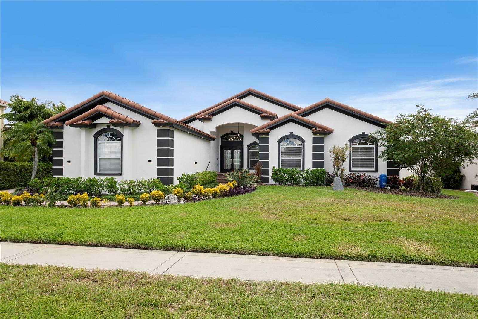 Welcome home to 6402 Rubia Circle in Andalucia, a beautiful gated community in Apollo Beach!