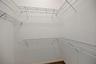 One of two walk-in closets in primary bedroom