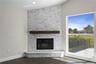 Beautiful wood-burning fireplace with elegant mantel and tile surround - a charming touch of character.