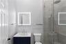 This elegantly appointed hall bath conveniently serves 2 of the bedrooms.
