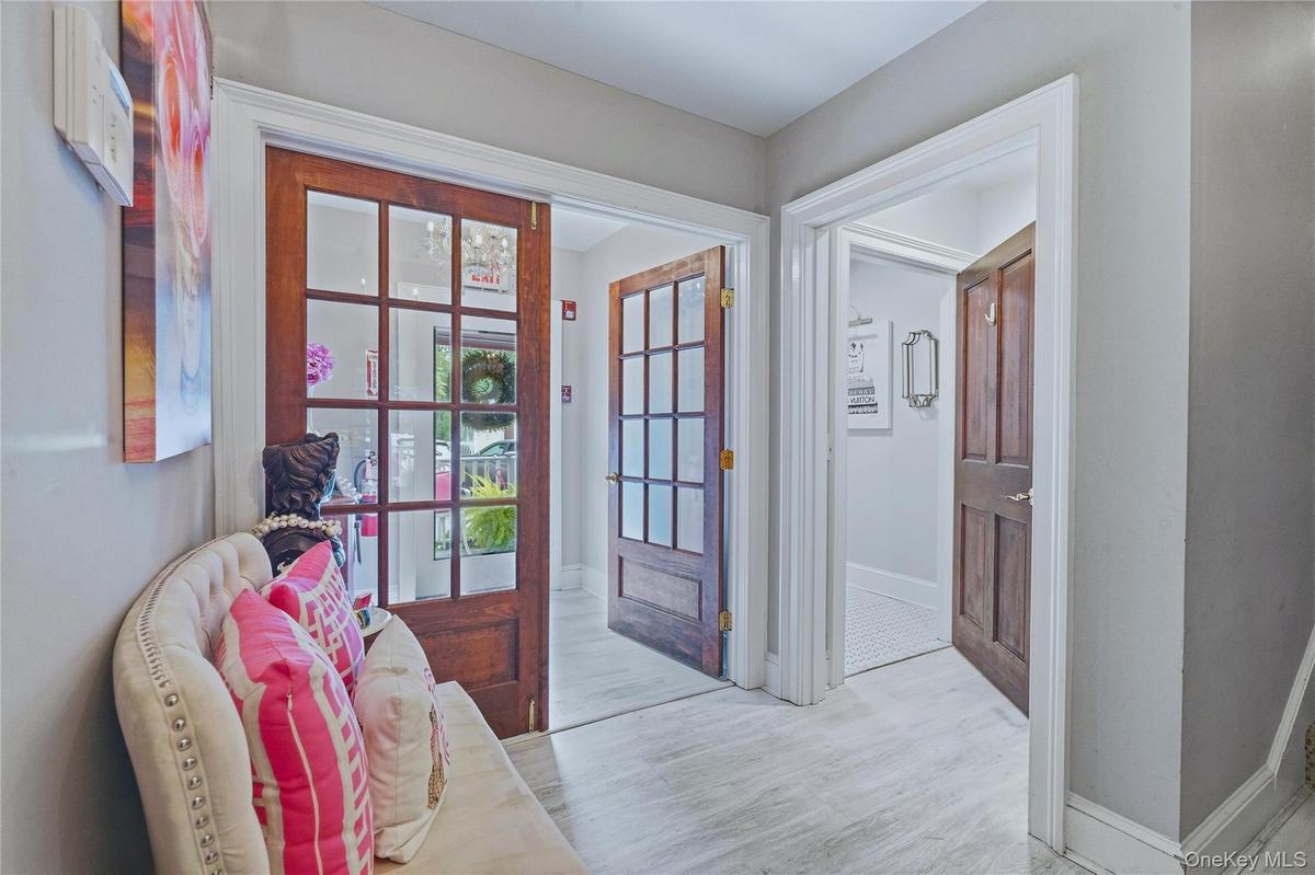 Entryway with Light-toned flooring, white trim, and light gray wall finishes