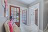 Entryway with Light-toned flooring, white trim, and light gray wall finishes