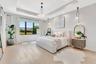 Spacious primary suite with tray ceiling detail, serene views, and a bright, airy layout designed for comfort.
