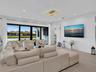 Spacious living area featuring clean modern finishes, recessed lighting, and seamless flow to the kitchen and dining spaces.