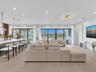 Spacious living area featuring clean modern finishes, recessed lighting, and seamless flow to the kitchen and dining spaces.