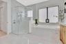 Spa-inspired primary bath featuring a frameless glass walk-in shower, modern finishes, and a clean, contemporary design.