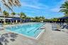 Resort-style community pool surrounded by expansive deck space and lounge seating.