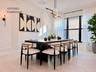 Spacious formal dining area featuring modern lighting, clean architectural lines, and seamless flow from the kitchen for entertaining.