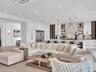 Spacious living area featuring clean modern finishes, recessed lighting, and seamless flow to the kitchen and dining spaces.