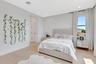 Bright bedroom featuring contemporary styling, oversized windows, and a clean, modern aesthetic.