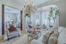 Hardwood flooring, ornate crown molding, decorative chandelier, bay window with plantation shutters, and an arched entry