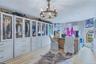 Custom built-in cabinetry with glass-front uppers, brass hardware, and ample drawer storage