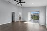 The primary bedroom features sliding doors that lead to the private deck.