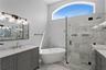 The elegant primary bath features dual vanities, a luxurious soaking tub and oversized walk-in shower.
