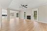 Inviting family room with fireplace and French doors leading to the back porch and pool deck