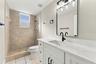Downstairs hall bathroom with brand new vanity, mirror, lighting and fixtures