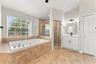 Large jacuzzi bathtub with separate shower stall