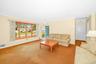 With large bay window and carpeting