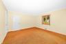 Primary bedroom carpeted. Hardwood under carpet