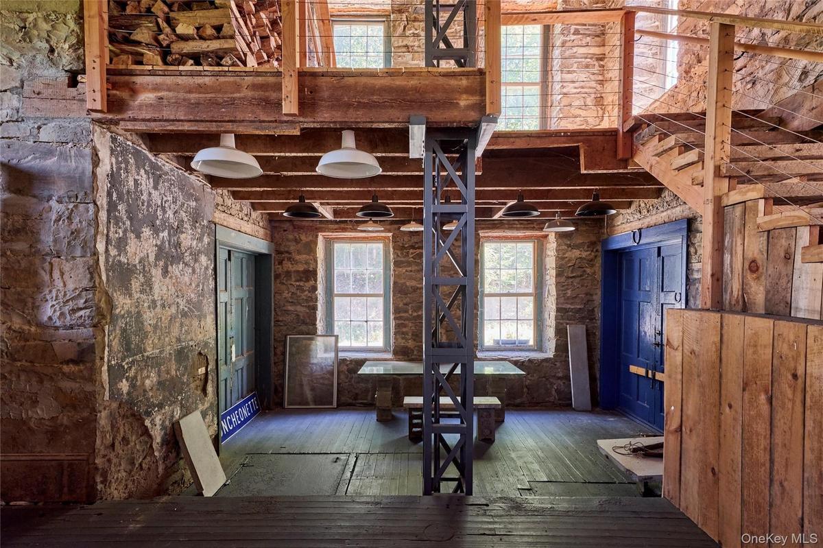 Miscellaneous room with hardwood / wood-style flooring and beamed ceiling