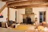 Living room with a premium fireplace, beamed ceiling, and hardwood / wood-style floors