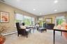 Recessed lighting illuminates neutral-toned walls and plush carpeting Of this Large Family Room with Gas Fireplace