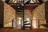 Staircase featuring beamed ceiling, a towering ceiling, and wood-type flooring