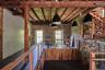Hallway featuring a wood ceiling with exposed beams, an upstairs landing, and dark wood finished floors