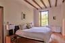 Bedroom featuring radiator, beam ceiling, and hardwood / wood-style flooring