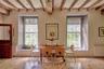 Dining area featuring radiator heating unit, beam ceiling, and hardwood / wood-style flooring