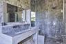 Full bath with vanity and a marble finish shower