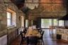 Dining space featuring dark wood-type flooring, radiator heating unit, high vaulted ceiling, and beamed ceiling