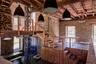 Stairs featuring a wood ceiling with exposed beams