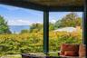 A beautifully designed covered outdoor lounge offering stunning Hudson River views, comfortable seating, and a peaceful setting to enjoy the surroundi