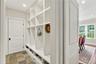 A thoughtfully designed mudroom featuring four custom built-ins and three spacious custom closets, offering exceptional storage, organization, and eve