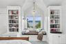 A charming custom window seat framed by built-in bookshelves, offering breathtaking Hudson River views and a peaceful retreat within the bedroom.