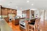 A chef-inspired kitchen featuring two expansive islands, premium built-in appliances, custom cherry cabinetry with thoughtfully designed storage in ev