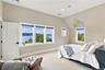 A oversized, light-filled bedroom featuring beautiful architectural details and expansive windows showcasing breathtaking Hudson River views with en s