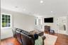 A spacious and inviting sitting room featuring abundant natural light, elegant finishes, and a comfortable setting for relaxation and entertainment.