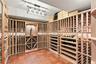 An impressive custom wine cellar with storage for approximately 1,200 bottles, complete with temperature and humidity control for ideal preservation a