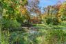 View from the rear showing the pond and the back of the main house.
