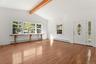 Living room with picture window and beamed ceilings
