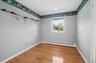 Third bedroom with hardwood floors and recessed lighting.